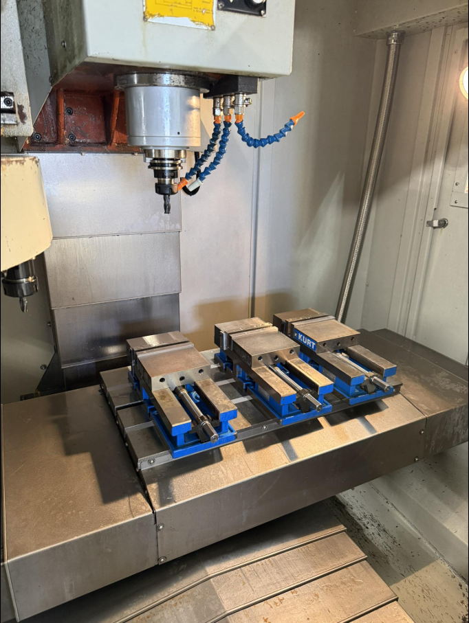 CNC machine interior with Kurt vises set up for a production run